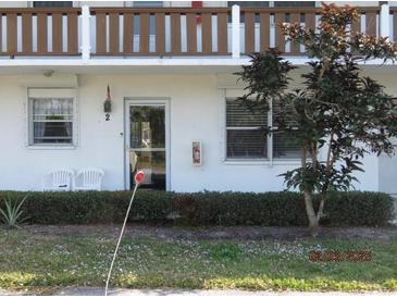 Charming condo featuring well-maintained landscaping, a cozy entryway, and a classic architectural design at 1 Quails Run Blvd # 2, Englewood, FL 34223
