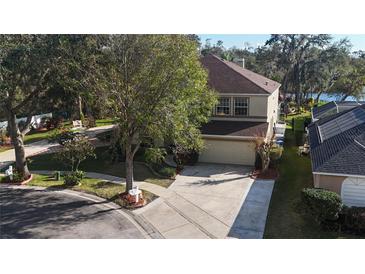 Two-story home on a corner lot featuring mature trees, a large driveway and a two car garage at 732 June Lake Ln, Brandon, FL 33510