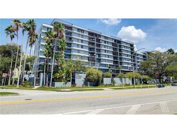 Apartment building exterior, sign says, 'One Laurel Place', has palm trees and nice landscaping at 201 W Laurel St # 1006, Tampa, FL 33602