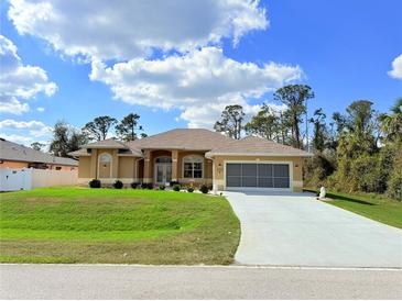 Inviting single Gathering home with tan paint, manicured lawn, and a screened two-car garage at 2329 Como St, Port Charlotte, FL 33948