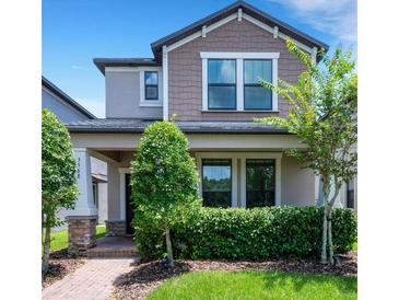 Charming two-story home with a well-maintained lawn and tasteful landscaping at 3568 Pine Ribbon Dr, Land O Lakes, FL 34638