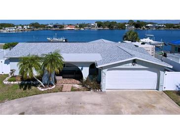 Charming waterfront home with a two-car garage, well-maintained landscaping, and beautiful water views at 4941 Waterside Dr, Port Richey, FL 34668