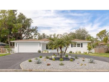 Charming single-story home with circular driveway, professional landscaping, and meticulous exterior at 6655 Colony S Dr, St Petersburg, FL 33705