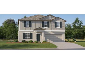 Charming two-story home with gray siding, a well-manicured lawn, and a two-car garage at 8442 Bella Mar Trl, Parrish, FL 34219