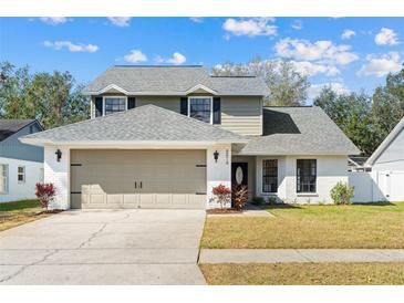 Charming two-story home featuring a well-maintained lawn and neutral two-car garage at 8814 Hampden Dr, Tampa, FL 33626