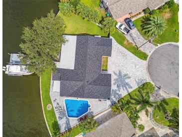 Aerial view of renovated home and pool on waterfront property with dock and lush tropical landscaping at 1514 Sea Gull S Dr, St Petersburg, FL 33707