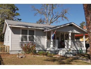 Charming single-story home with a cozy front porch and well-maintained landscaping at 1736 14Th N St, St Petersburg, FL 33704