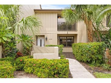 Charming townhouse featuring lush tropical landscaping and a cozy second-story balcony at 4620 Hidden View Pl # 10, Sarasota, FL 34235