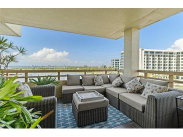 Spacious balcony featuring comfortable seating, plants, and scenic waterfront views on a sunny day at 5701 Mariner St # 606, Tampa, FL 33609