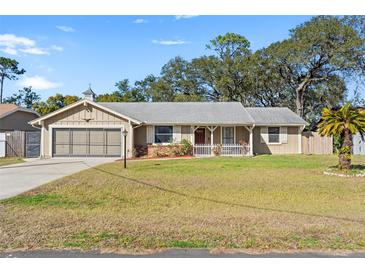 Charming single-story home with a well-maintained lawn and inviting front porch at 8449 Valmora St, Spring Hill, FL 34608