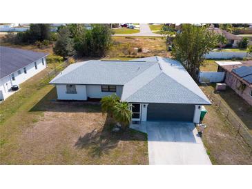 Charming single-story home featuring a two-car garage and manicured front yard at 17319 Terry Ave, Port Charlotte, FL 33948