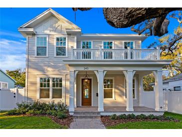 Charming two-story home with a welcoming front porch, balcony, and meticulously maintained landscaping at 243 28Th N Ave, St Petersburg, FL 33704