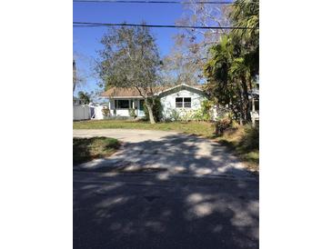 Charming single-story home featuring a neatly manicured front yard and a welcoming, light-blue entrance door at 3650 Bayshore Ne Blvd, St Petersburg, FL 33703