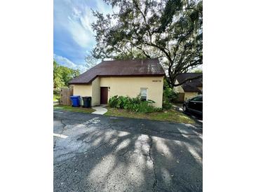 A charming, one-story home featuring a well-maintained lawn and a designated parking spot at 5627 Ashley Oaks Dr # 4, Tampa, FL 33617