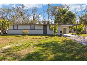 Charming single-story home with a spacious front yard and covered carport at 306 Midwood Dr, Plant City, FL 33566