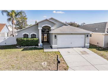 Charming single-story home with well-maintained lawn and attached two-car garage at 7911 Floradora Dr, New Port Richey, FL 34654