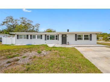 Charming single-story home features fresh paint, black shutters, and a well-maintained front yard at 1404 Wood Ave, Clearwater, FL 33755