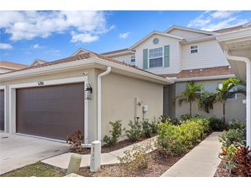 Charming two-story townhome with a one-car garage and a well-maintained landscaped front yard at 5286 Neil Dr, St Petersburg, FL 33714
