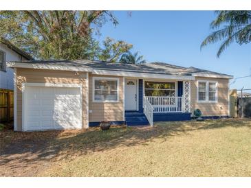 Charming one-story home featuring a front porch and a single car attached garage at 5502 N 9Th St, Tampa, FL 33604