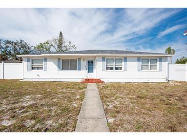 Charming single-story home with white siding, blue shutters, and well-maintained landscaping at 701 63Rd S St, Gulfport, FL 33707