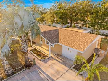 Aerial view of a well-maintained property with lush landscaping and a private driveway at 7507 Betula Dr, New Port Richey, FL 34653