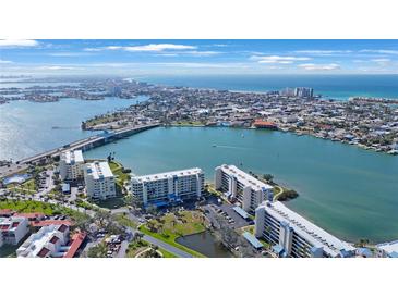 Breathtaking aerial view of beachfront condos surrounded by water and coastline on a sunny day at 7892 Sailboat Key S Blvd # 307, South Pasadena, FL 33707