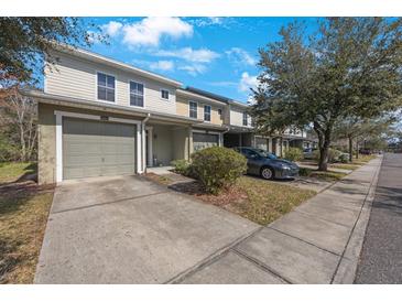 Townhome exterior showing attached garage, and manicured lawn at 8004 Downpatrick Ct, Tampa, FL 33610