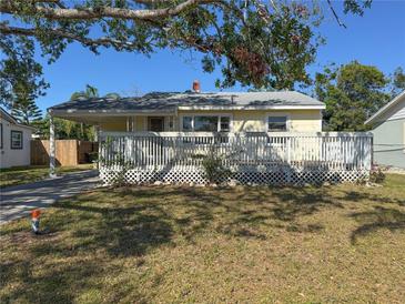 Charming single-story home featuring a cozy front porch, lush lawn, and convenient covered parking at 808 20Th W Ave, Bradenton, FL 34205