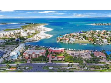 Stunning aerial view of waterfront property, showcasing the community and the beautiful turquoise ocean and nearby beaches at 1060 Pinellas Bayway S # 103, St Petersburg, FL 33715