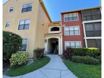 Inviting condominium building exterior with manicured landscaping and walkway to the units' entrance at 11901 4Th N St # 10102, St Petersburg, FL 33716