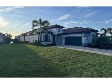 Charming single-story home features a manicured lawn and a two-car garage at 17736 Hickok Belt Loop, Bradenton, FL 34211