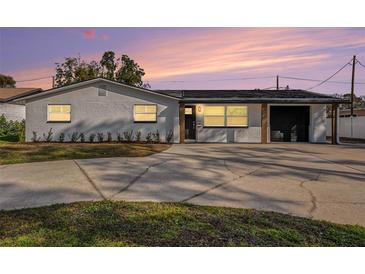 Charming single-story home with a brick facade, black trim, well-maintained lawn and long driveway at 239 Freeport Ne Ave, St Petersburg, FL 33702