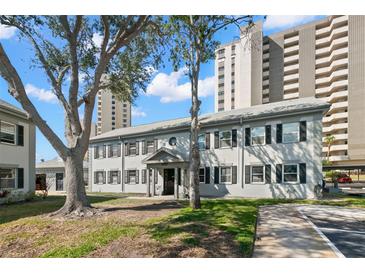 Charming condo building with mature trees and well-maintained landscaping at 6980 Avenue Des Palais # 2A, South Pasadena, FL 33707