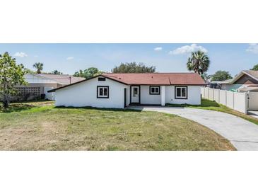 Charming single-story home featuring a well-maintained lawn and a classic exterior design at 8705 Tahiti Ln, Tampa, FL 33615