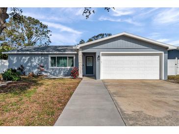 Charming single-story home features a well-manicured lawn and an attached two-car garage at 9394 117Th Ave, Largo, FL 33773