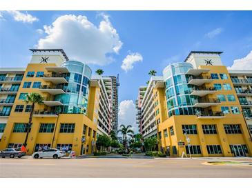 Beautiful building exterior featuring modern architecture, blue skies and palm trees at 1208 E Kennedy Blvd # 1115, Tampa, FL 33602