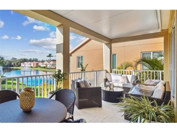 Relaxing outdoor patio with comfortable seating overlooking a scenic lake and water fountain at 18 Franklin S Ct # D, St Petersburg, FL 33711