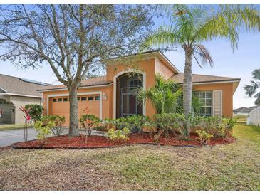 Charming single-story home with an attached two-car garage, mature landscaping, and a screened-in porch at 2340 Lawrence Hall St, Ruskin, FL 33570