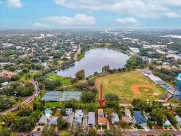 Desirable neighborhood aerial view features lake, tennis courts, and baseball field near the charming home at 605 12Th N Ave, St Petersburg, FL 33701