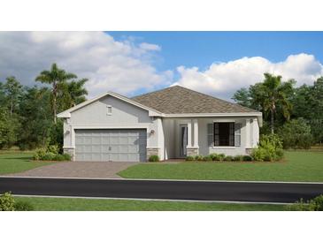 Charming one-story home featuring a two-car garage, well-maintained lawn, and neutral color palette at 8644 Saint Kitts Cir, Englewood, FL 34224