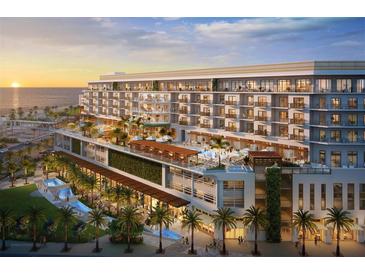 Stunning new high rise resort featuring a large deck, multiple pools and tropical landscaping at sunset at 15000 Madeira Way # 527, Madeira Beach, FL 33708