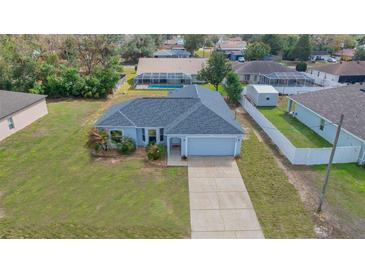 Charming one-story home with well-maintained lawn and attached garage on a sunny day at 4306 Goldcoast Ave, Spring Hill, FL 34609