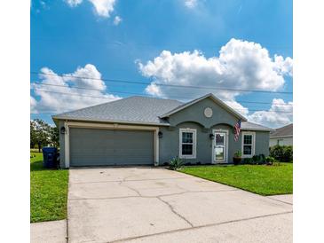 Charming single-story home with well-maintained lawn and two-car garage at 5106 Tanner Rd, Spring Hill, FL 34609