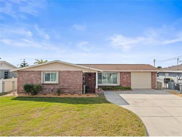 Charming brick home with a well-maintained lawn and inviting curb appeal at 6518 Leeside Isle, Hudson, FL 34667