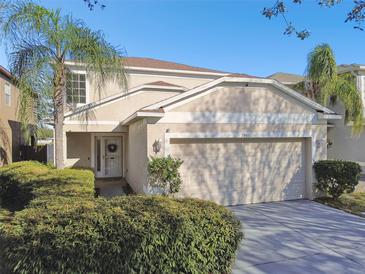 Charming two-story home with manicured landscaping, a two-car garage, and a welcoming entrance at 7945 Carriage Pointe Dr, Gibsonton, FL 33534