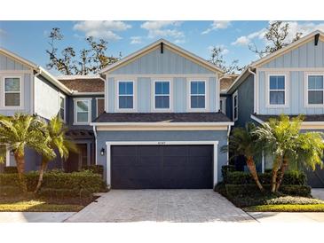 Charming two-story townhome featuring an attached garage and well-manicured landscaping at 4549 Chinkapin Dr, Sarasota, FL 34232