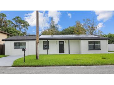 Charming single-story home with a well-maintained lawn and dark trim accents at 6291 63Rd N St, Pinellas Park, FL 33781
