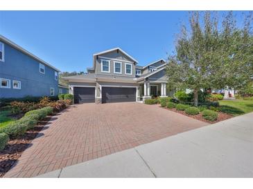 Charming home featuring a manicured front yard, brick driveway and a 2-car garage at 6640 Park Strand Dr, Apollo Beach, FL 33572