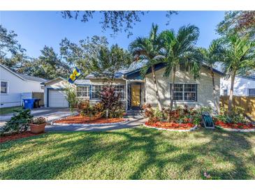 Charming home featuring lush landscaping, a well-manicured lawn, and beautiful exterior at 1061 45Th N Ave, St Petersburg, FL 33703