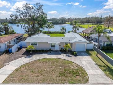 Charming single-story home with a circular driveway and lake view at 1230 75Th N Ave, St Petersburg, FL 33702